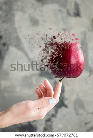 Disintegrating levitating red apple 