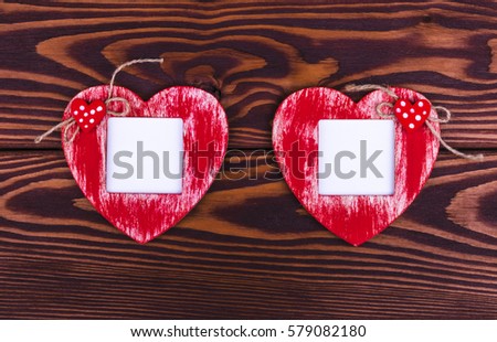 Love card template with blank photo frame heart shaped on the red hearts on wooden background