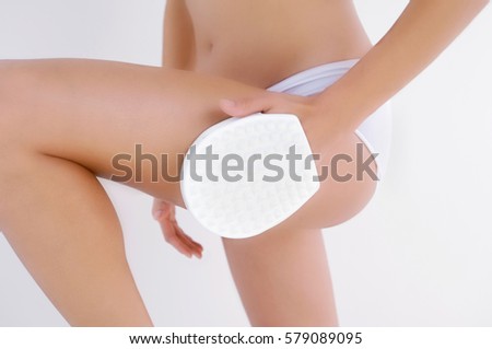 Slim woman doing cellulite massage