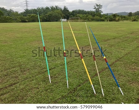 colourful javelin in grass , field .