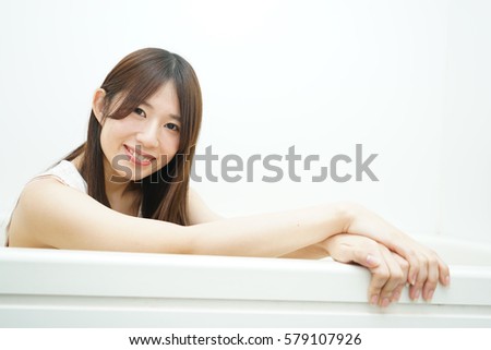 Young woman washing clothes in her room