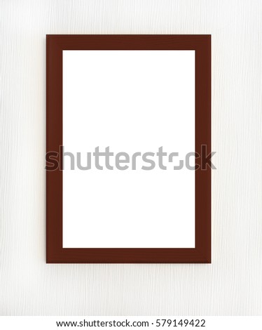 Dark wooden frame with blank picture isolated on white wall