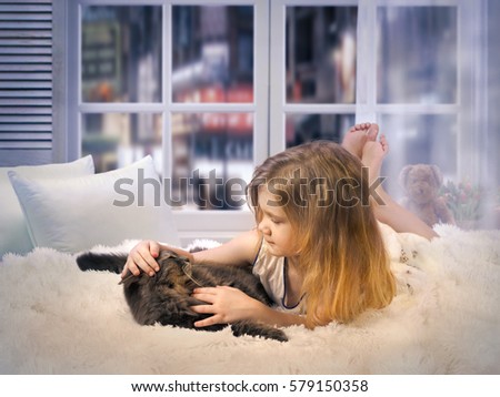 The child stroked the cat lying on the bed by the window