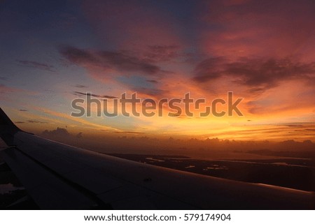 red sunset on front of aircraft wing.