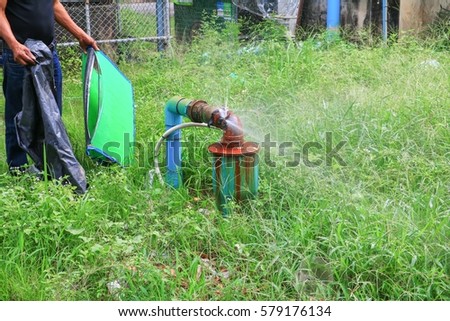 plumbing main tube and water leak,  old tap pipe steel rust  on grass floor