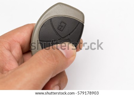 Car key remote control with hand hold it isolated on white photo-realistic vector illustration
