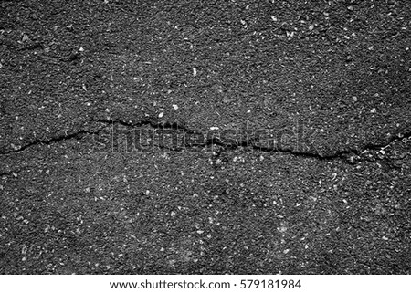 crack and texture of asphalt road - top view background.
