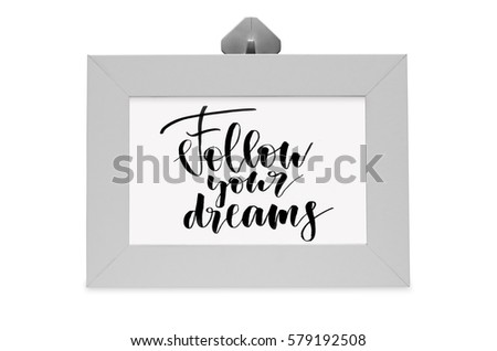Handwritten text. Follow your dreams. White photo frame. Modern calligraphy. Isolated on white background