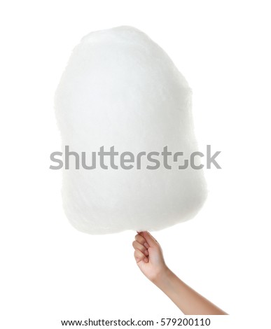 Female hand holding cotton candy on white background