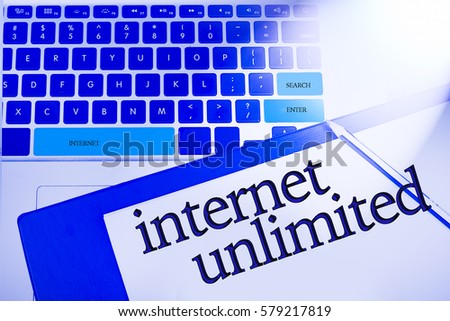 Internet Unlimited word in business concepts, technology background in laptop and notepad