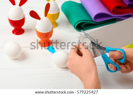 Female hands making Easter decor