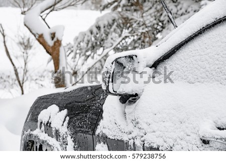 Close up of car cover by snow parking on the road Japan.