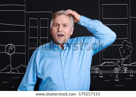 Emotional elderly man looking at the traffic jam