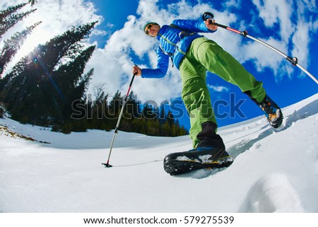 hiker with backpack on the trail in the Carpathians mountains at winter. picture of hiker taken on wide angle from low point