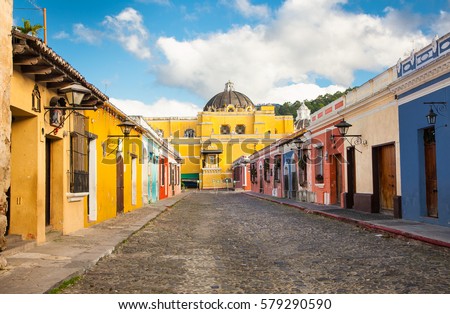  La Merced church and colonial houses in tha street view of Antigua, Guatemala.  The historic city Antigua is UNESCO World Heritage Site since 1979. Royalty-Free Stock Photo #579290590
