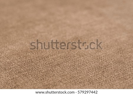 Beige fabric texture. Abstract background, empty template. Selective focus.
