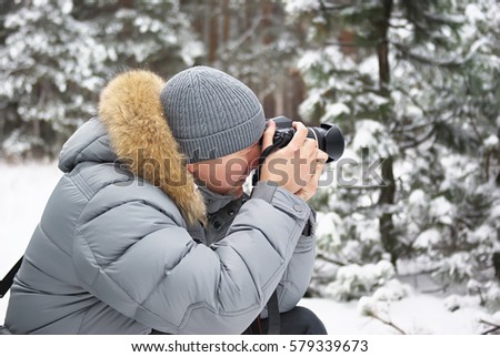 Winter forest man professional photographer
