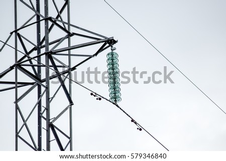 Glass prefabricated high voltage insulators on poles high-voltage power lines. Electrical industry.