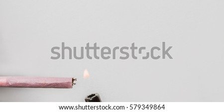 Lighter and a pink cigarette isolated on white background.