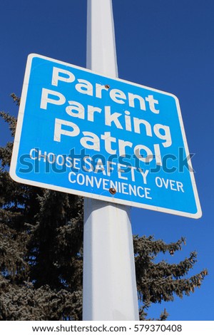 Parent Parking Patrol Sign Against Tree and Blue Sky