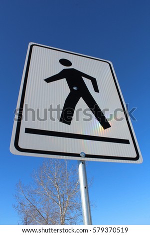 Crosswalk on a White Rectangle Sign