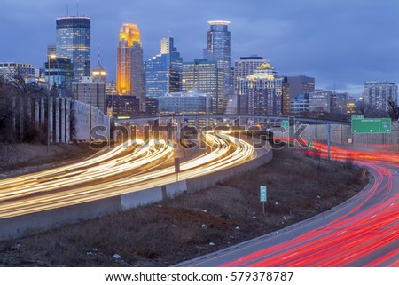 Telephoto Shot of Minneapolis and Curving Traffic Trails on the Highway during a Winter Twilight