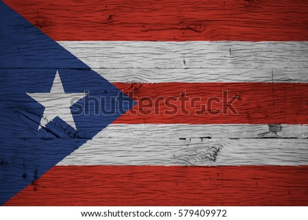 Puerto Rico national flag painted on old oak wood. Painting is colorful on planks of old train carriage.