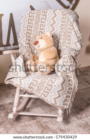 Plush bear in the armchair