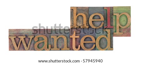 help wanted words in vintage wooden letterpress printing blocks, stained by color inks, isolated on white