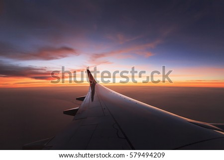 The sun sets on a plane