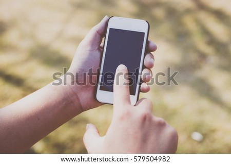 Close up of a man using mobile smart phone outdoor