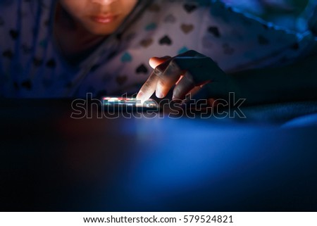 Women using smartphone in dark