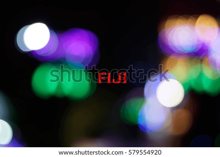 Multicolor light from LED lights close up and bokeh with a wording of FIJI. Country name concept for education. Image has grain or blurry or noise and soft focus when view at full resolution.