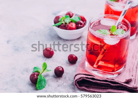 Summer drink concept. Cherry lemonade, cola, cocktail in a  glass on gray table background.