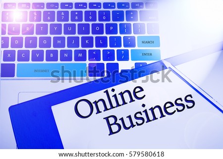 ONLINE BUSINESS word / term  in business concepts, technology background in laptop and notepad