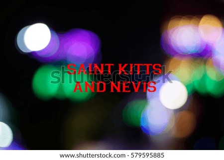 Multicolor light from LED lights close up and bokeh with a wording of SAINT KITTS AND NEVIS. Country name concept for education. Image has grain or blurry or noise and when view at full resolution.