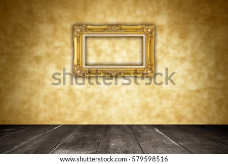 Gold frame on orange wall blur background for texture.