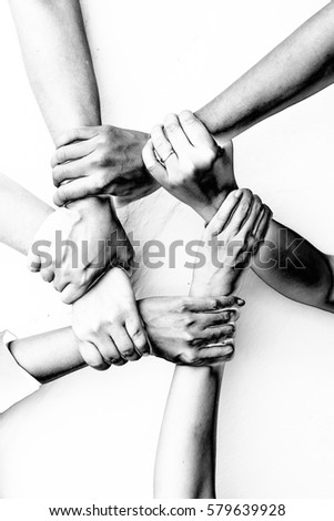 Business group United Hands together with Spirit in Solarization effect stype, teamwork concepts. Royalty-Free Stock Photo #579639928