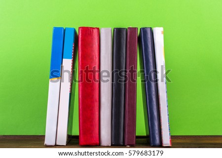 books in a row green background