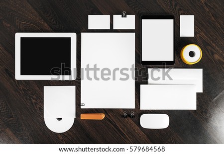 Blank corporate identity template on wooden table background. Photo of blank stationery. Mock up for design portfolios.