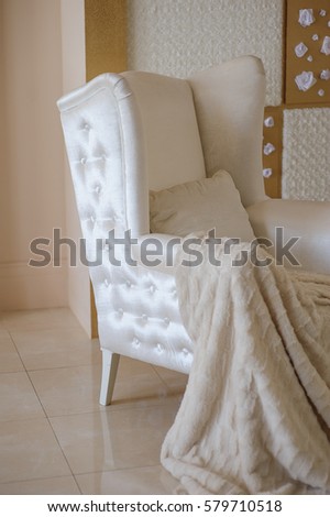 white chair with a blanket in the studio