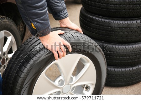 Closeup view of man rolling wheel outdoors