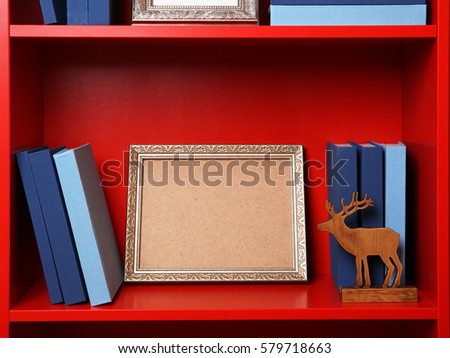 Set of books in row on white wooden shelving