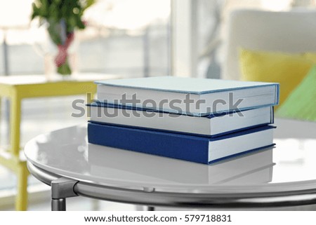 Pile of books on table at home