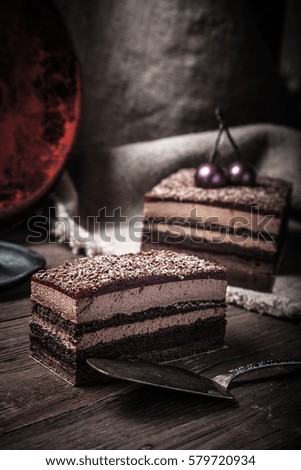 Homemade cherry cake with chocolate decor on a rustic style background. Selective focus. Toned.