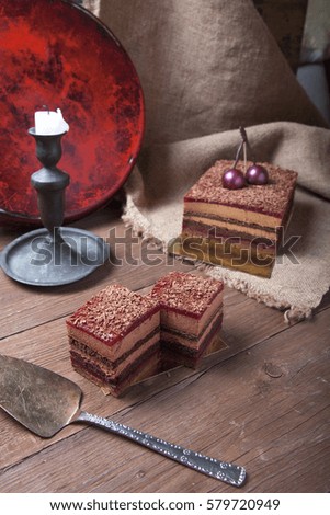 Homemade cherry cake with chocolate decor on a rustic style background. Selective focus.