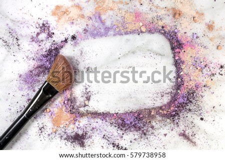 Makeup brush on white marble background, with traces of powder and blush forming a frame. A horizontal template for a makeup artist's business card or flyer design, with copy space