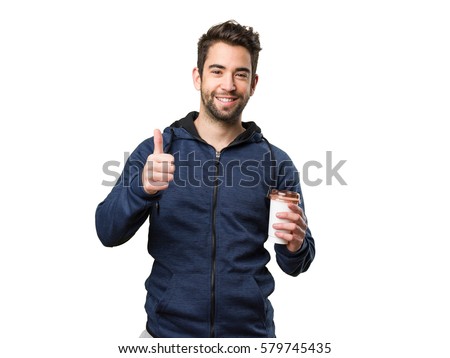 young man holding a coffee and doing okay gesture