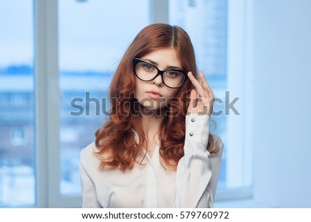 business woman with glasses wearing a white shirt against the backdrop of the city  brunette .