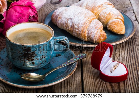 Festive breakfast of espresso, fresh croissant, flowers and gift on March 8, Birthday. Studio Photo